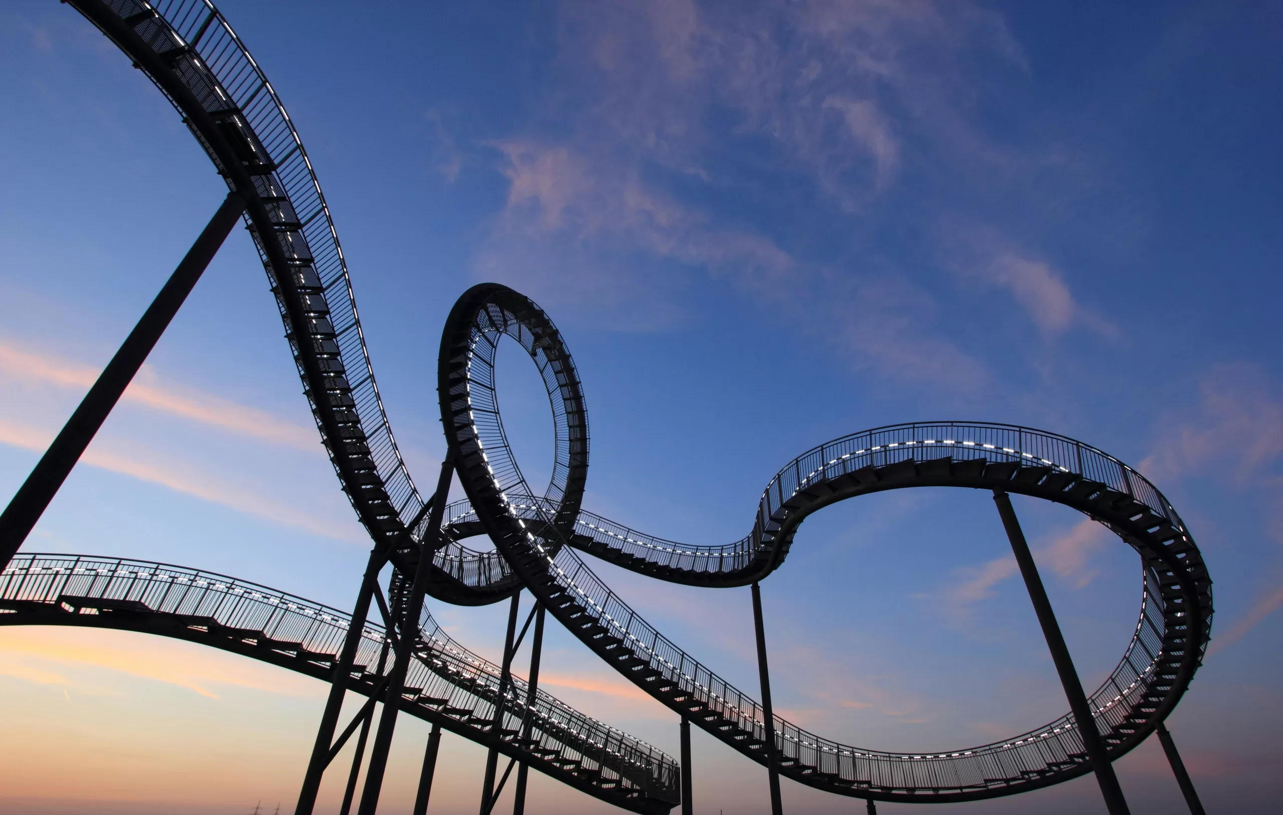 Roller coaster silhouette at sunset, capturing the theme park energy of a Los Angeles family vacation Day 1 in Anaheim