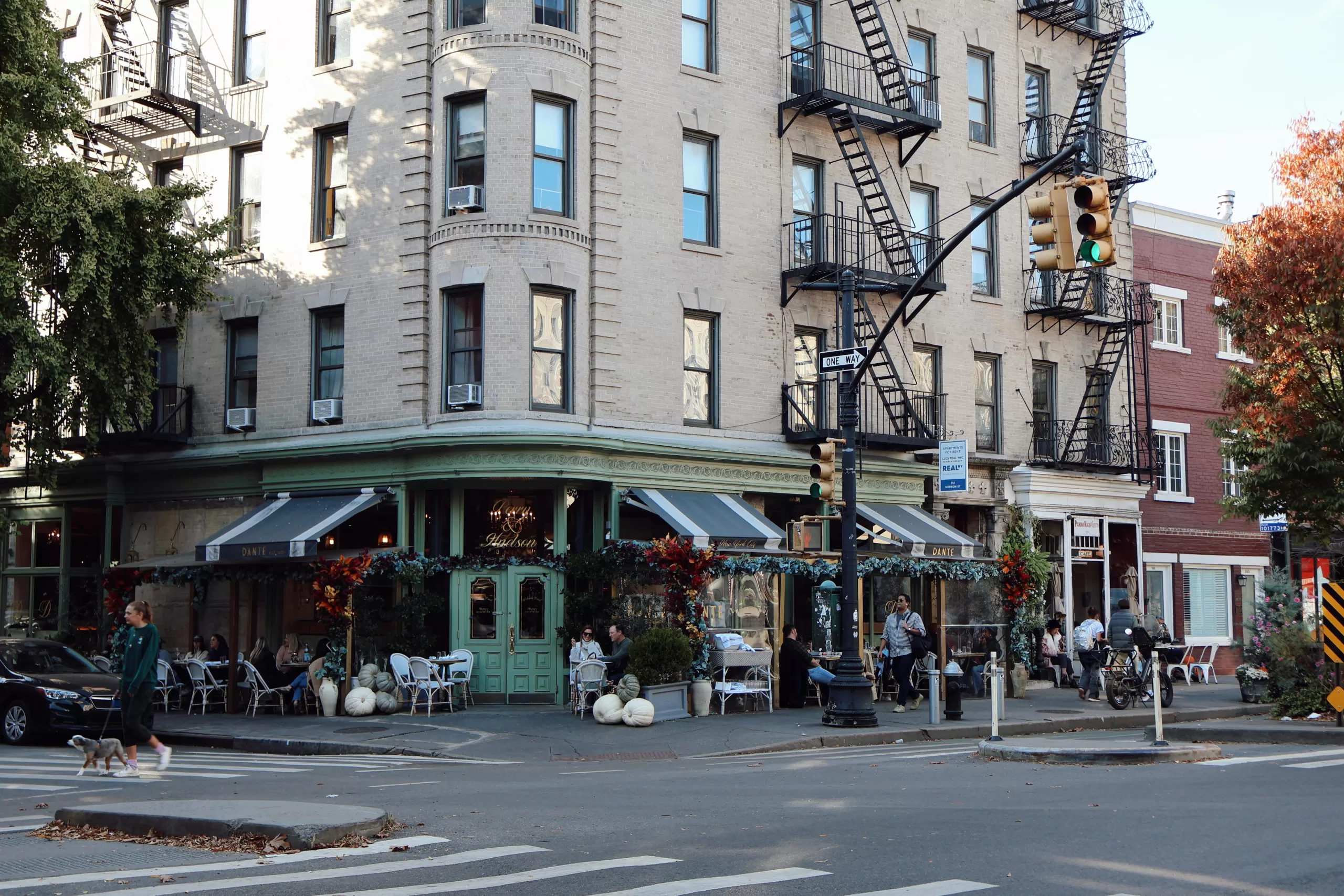 Charming Greenwich Village cafe with outdoor seating on a quiet New York City street corner, the Day 1 vibe of an NYC foodie tour