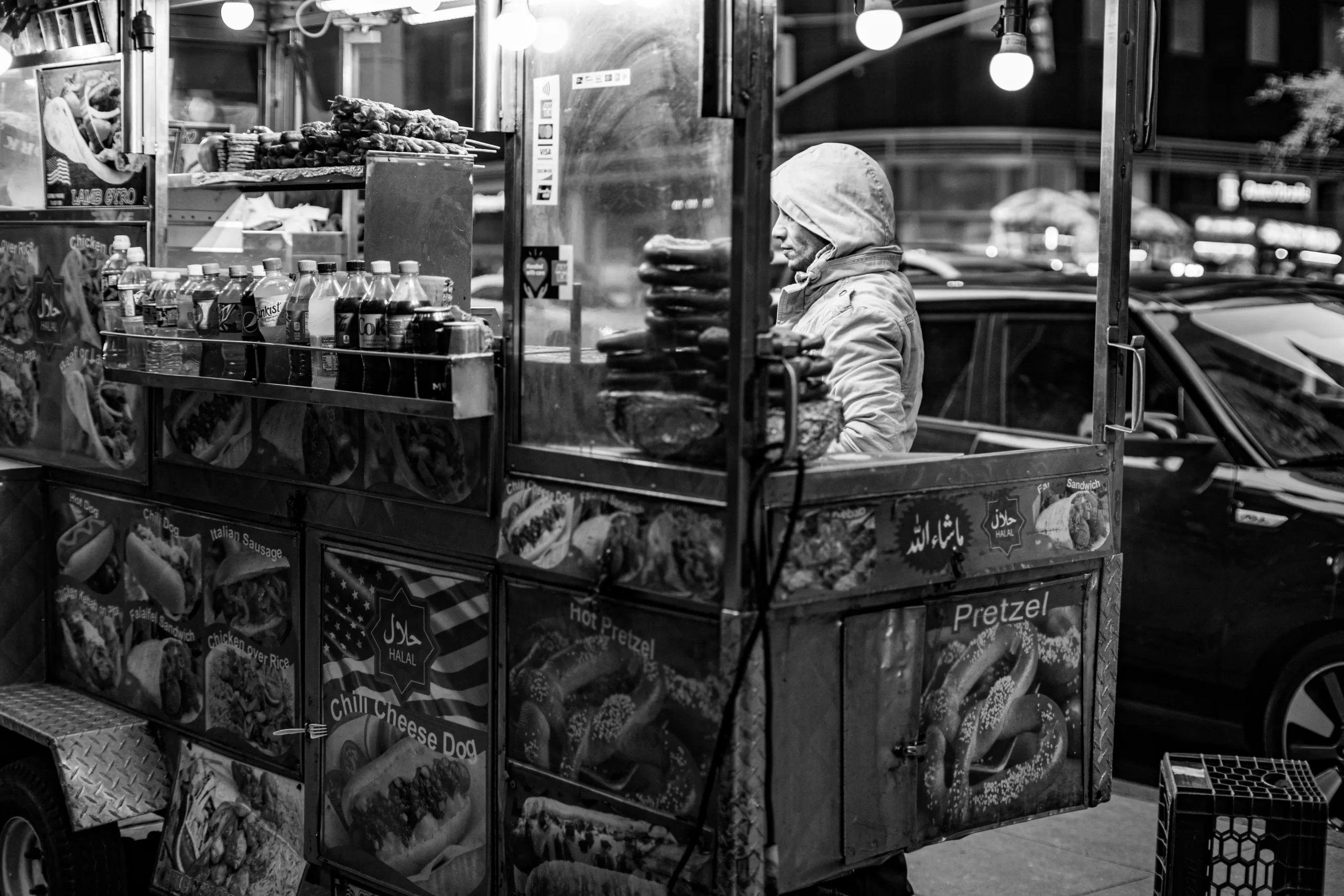 A New York City street food vendor selling hot dogs and pretzels, an iconic NYC foodie tour image